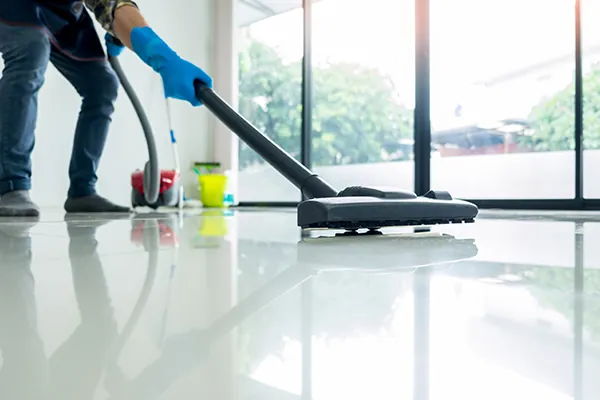 Cleaner vacuuming a floor