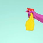 person home cleaning with a spray bottle
